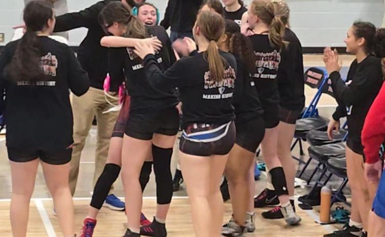 Brooklyn Myers (with headgear) is congratulated by Tessa Cosby and other OCHS teammates after a victory to help the girls wrestling team advance to its first state dual championship. The Patriots are one of eight teams remaining in Division 2. (Submitted Photo)