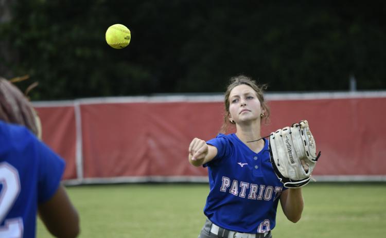 (ANDY MATHIS/THE OGLETHORPE ECHO) Oglethorpe County’s Emily Wisham warms up before a game against Clarke Central last Thursday. Wisham and fellow outfielder Zharia Burgess are two of OCHS’ “most energized players,” coach Brianna Dickens said.