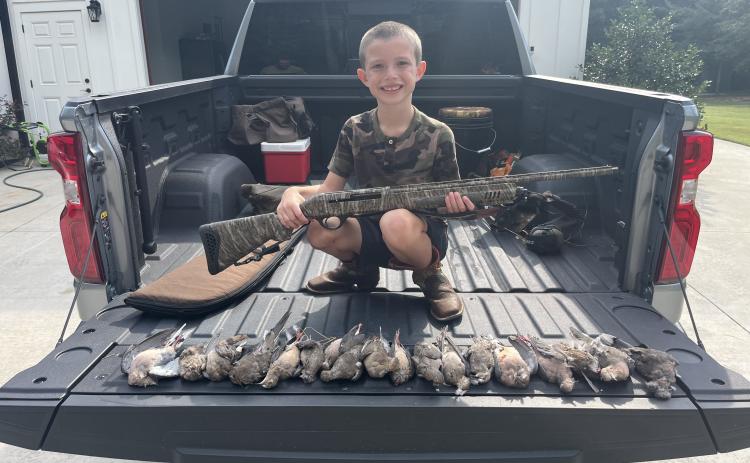 Young hunter Tate McDonald with his new shotgun and some of the doves he shot on Saturday at the Nation Family Farm. McDonald had a banner day in the field this year. Courtesy photo by Johnny Ralston (Submitted Photo/The Oglethorpe Echo).